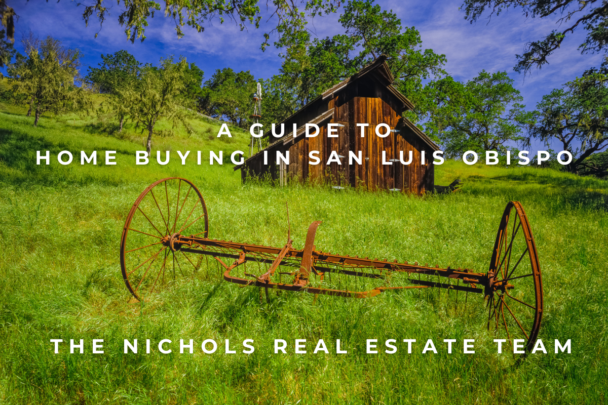 A photo of a rustic barn, with a horse carriage frame set in front, surrounded by a vibrant green grassy field. This photo represents the diverse San Luis Obispo County area and home buying market.